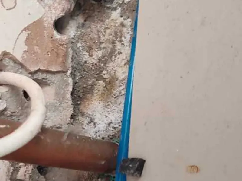 Salt deposits and damp around the manifold cupboard screed