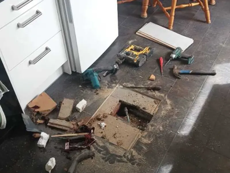 The kitchen floor opened up over the leaking supply connection